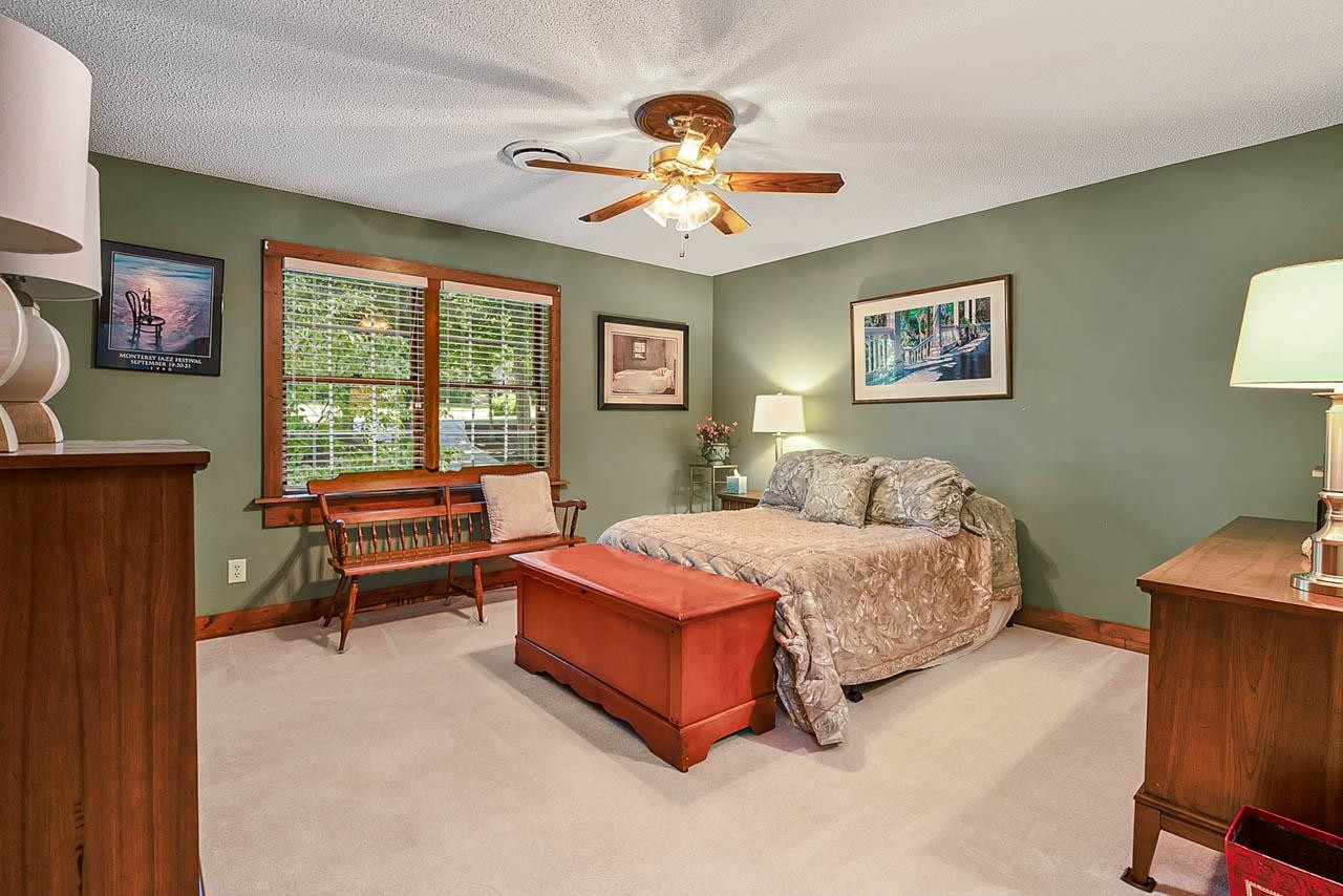 3109 Barnsley Lane Raleigh, NC 27604 - Photo 9 of 50 a spacious bedroom with a bed and a chandelier