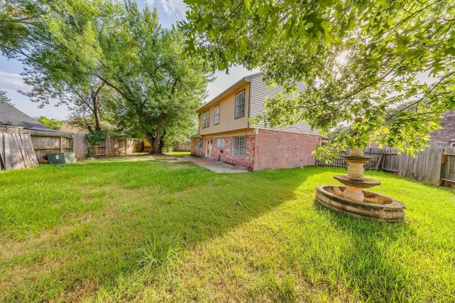 a view of a house with a backyard and a patio