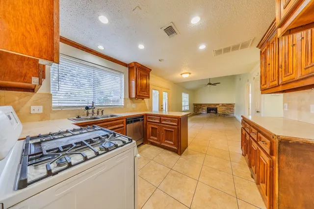 a kitchen with stainless steel appliances granite countertop a stove and a refrigerator