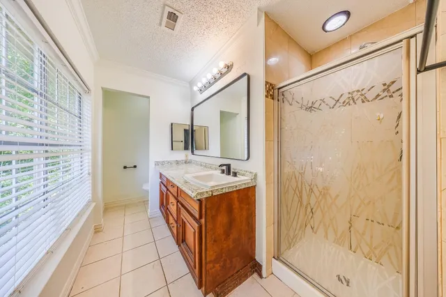 a bathroom with a shower and a sink