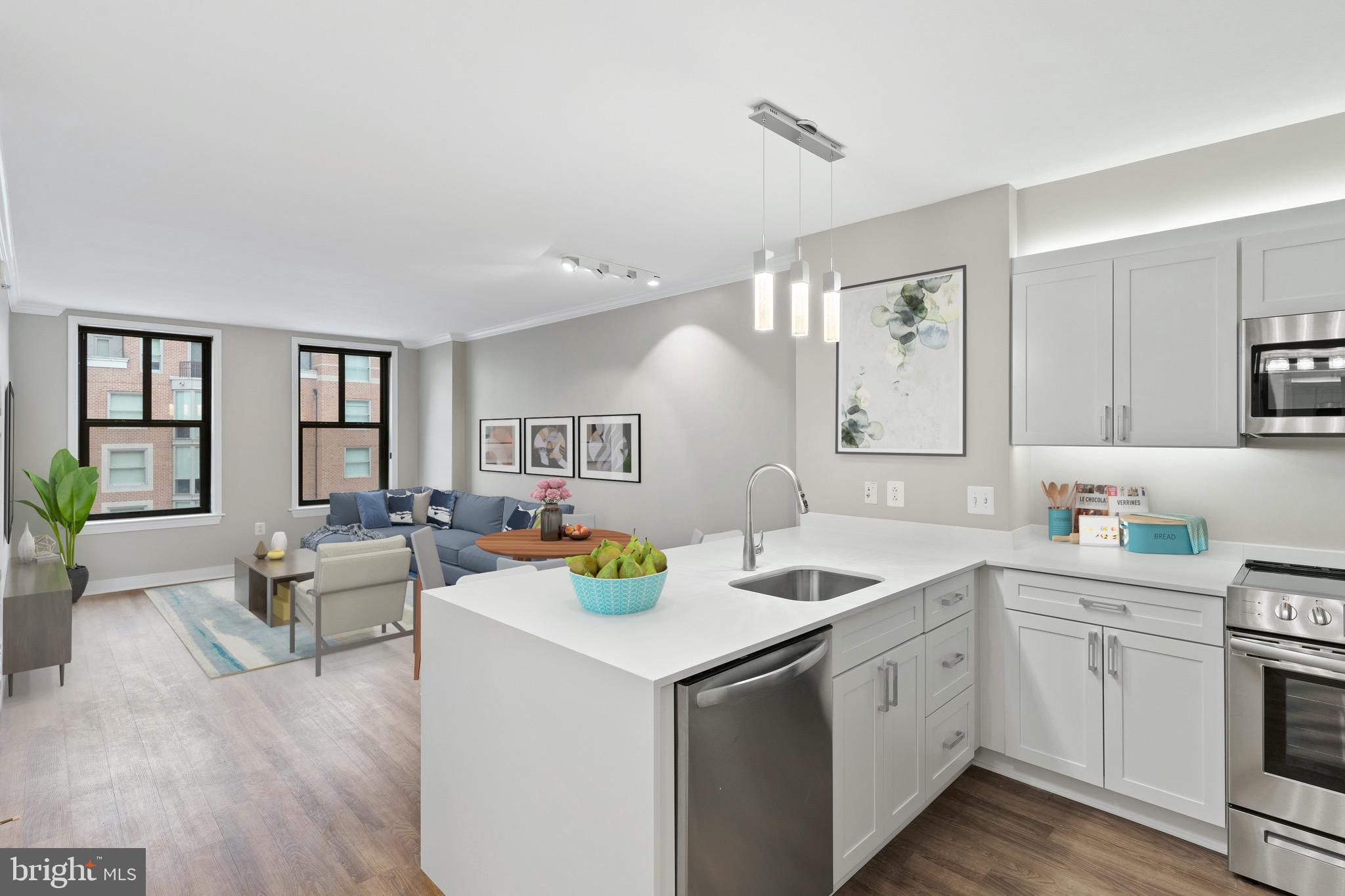 616 E Street Northwest, Unit 810 Washington, DC 20004 - Photo 14 of 15 a kitchen that has a sink a stove and chairs with wooden floor