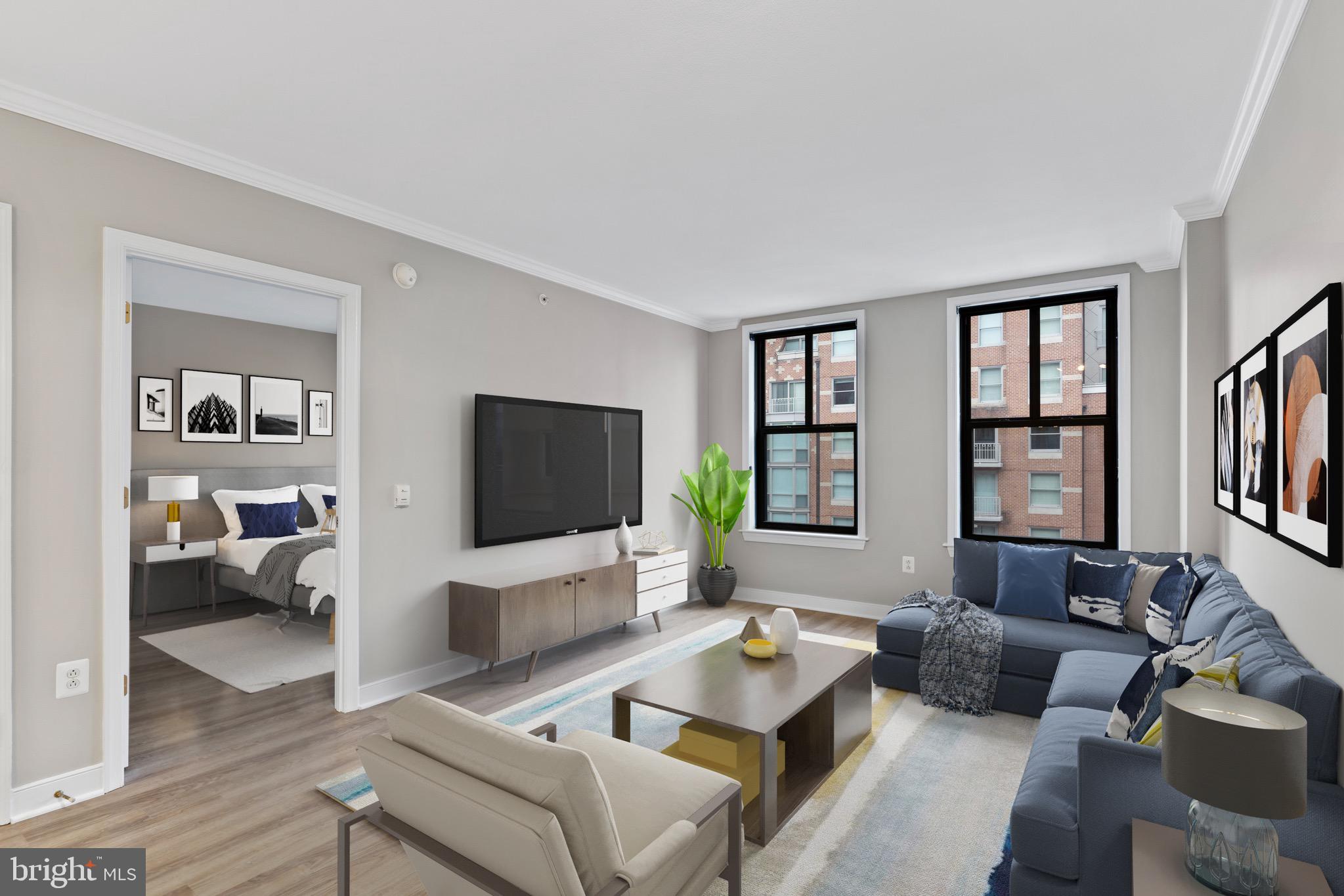 616 E Street Northwest, Unit 810 Washington, DC 20004 - Photo 4 of 15 a living room with furniture or couch and a flat screen tv