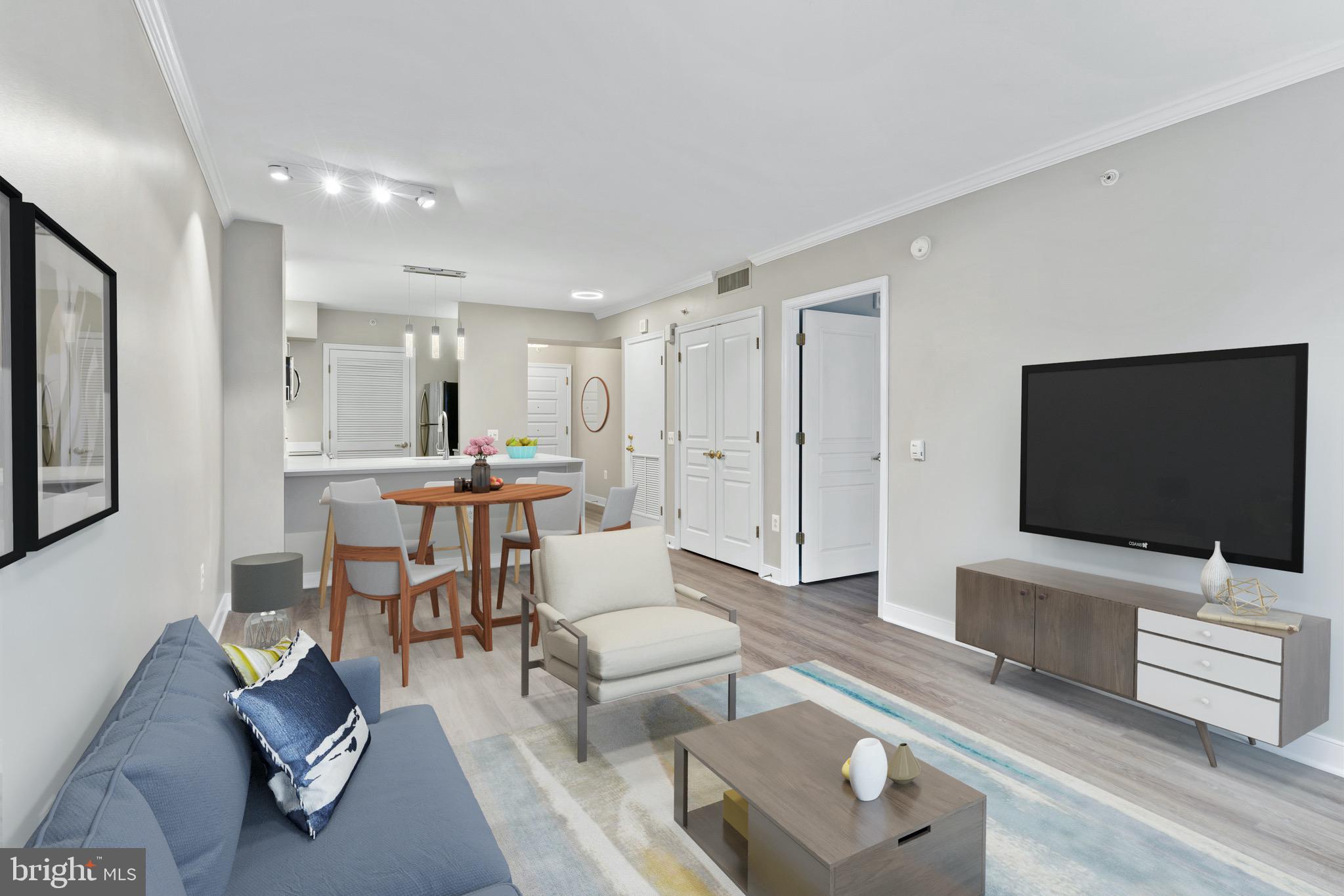 616 E Street Northwest, Unit 810 Washington, DC 20004 - Photo 5 of 15 a living room with furniture and a flat screen tv