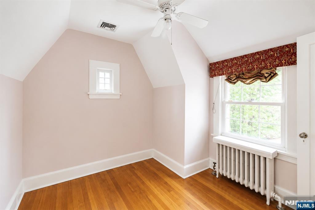 298 Audubon Road Englewood, NJ 07631 - Photo 12 of 19 a view of an empty room with wooden floor and a window