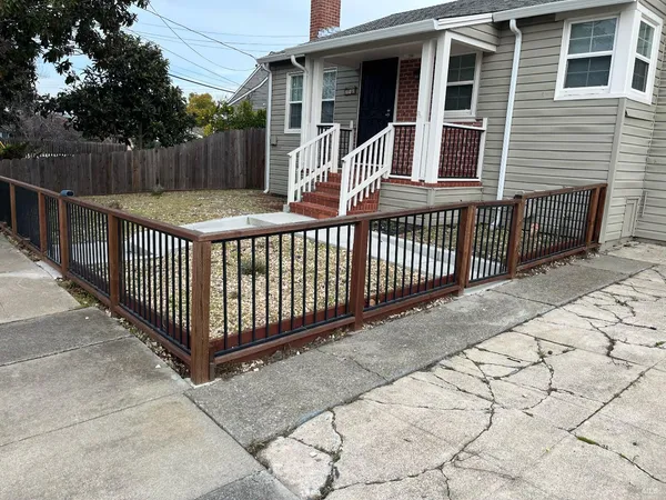 a view of a house with wooden fence