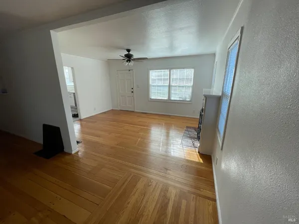 wooden floor in an empty room with a window