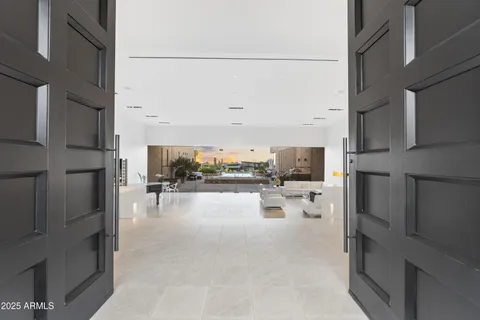 a living room with patio furniture and a view of kitchen