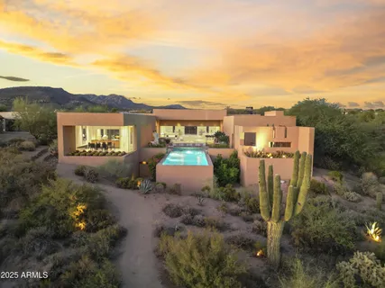 a view of a house with a yard and sitting area