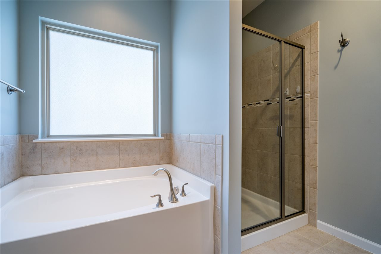1521 Rodessa Run Raleigh, NC 27607 - Photo 24 of 29 Relax at the end of a hard day in your garden tub and enjoy the separate shower in this spacious spa like owner's retreat. Owner's Bathroom