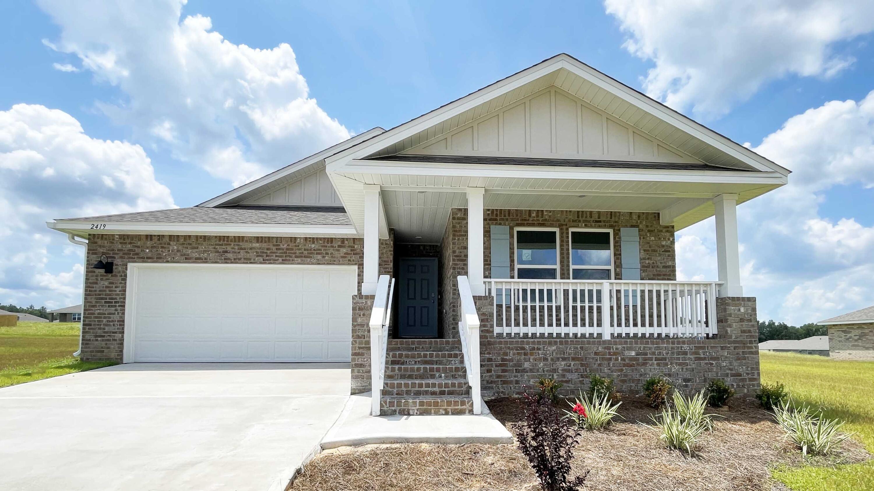 a front view of a house with garage