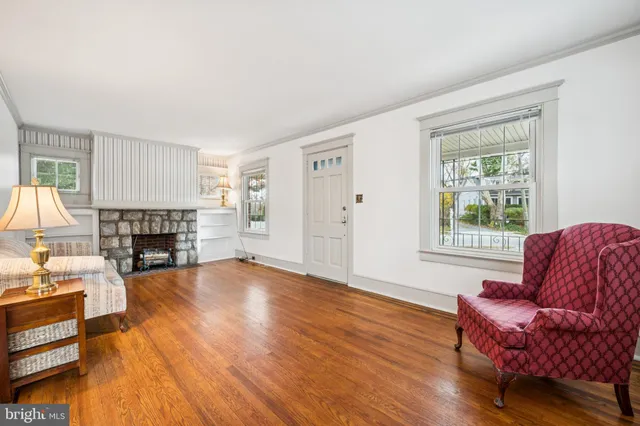 a living room with furniture a fireplace and a large window