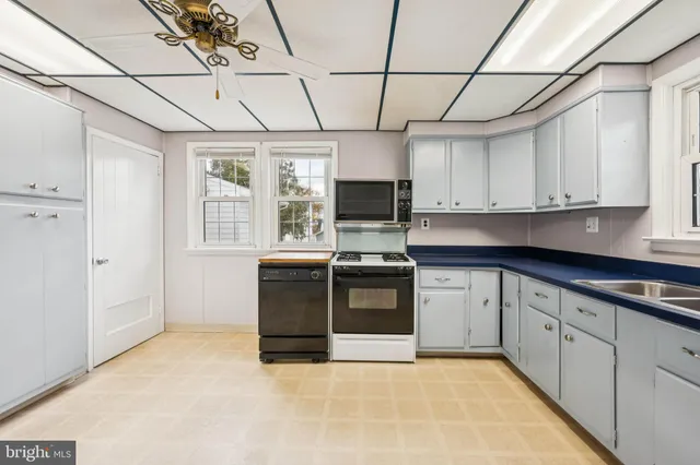 a kitchen with stainless steel appliances granite countertop a stove a sink dishwasher a refrigerator and a microwave