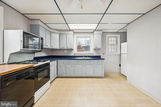 a kitchen with stainless steel appliances granite countertop a stove a sink dishwasher a refrigerator and a microwave