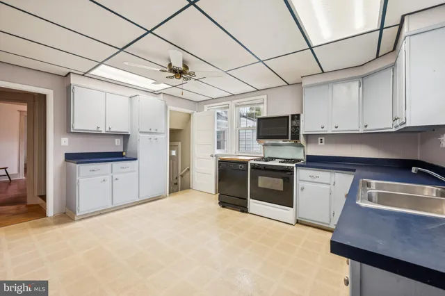 a kitchen with stainless steel appliances granite countertop a stove sink and refrigerator