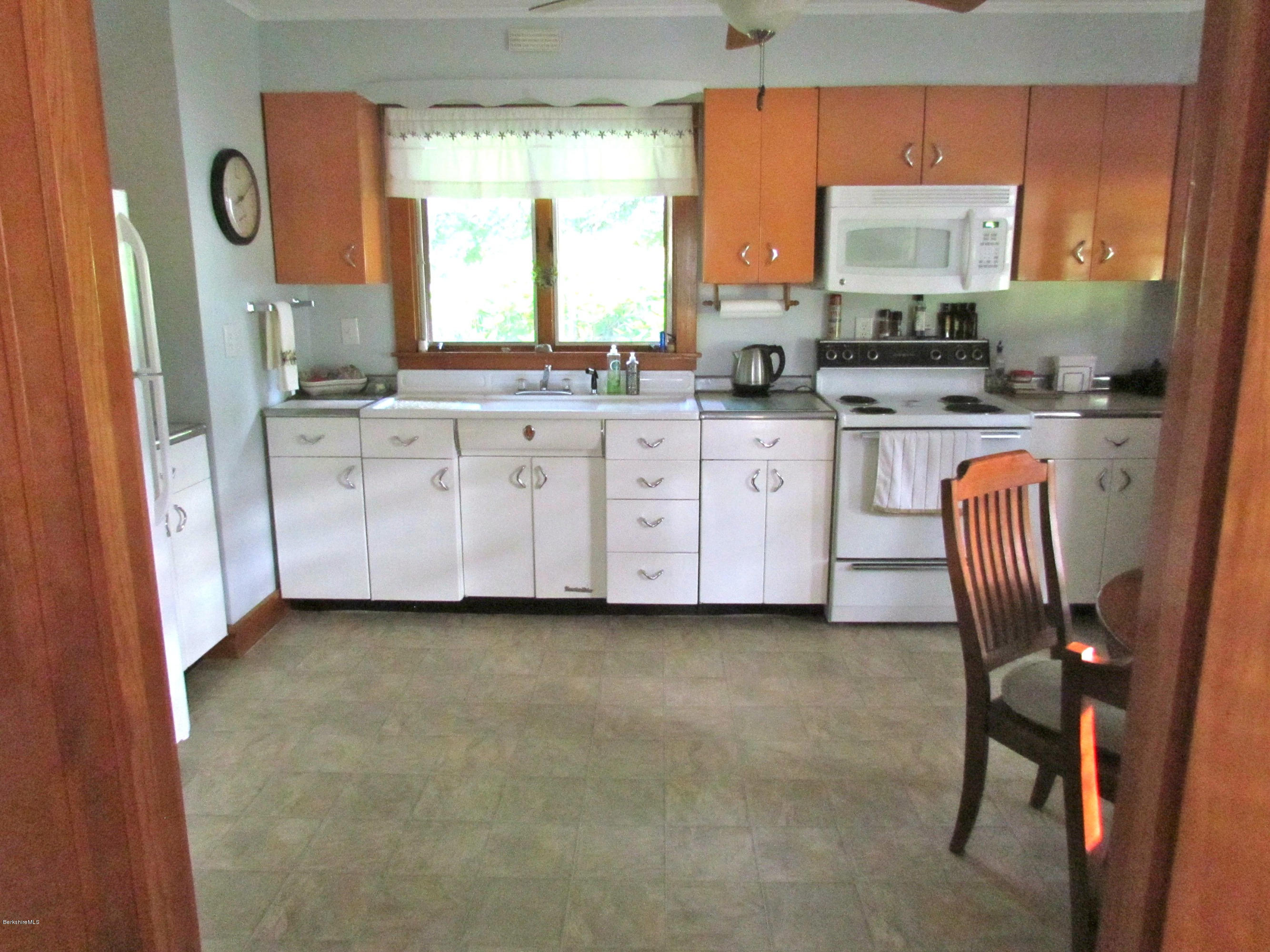 102 Clough Road Stamford, VT 05352 - Photo 2 of 13 a kitchen with granite countertop a sink window and cabinets