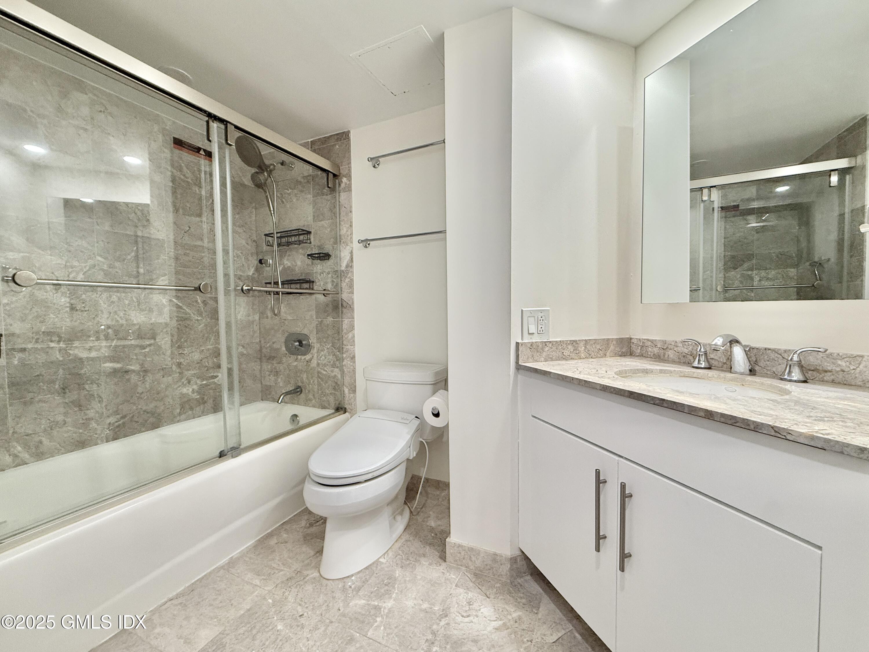 25 Forest Street, Unit 8C Stamford, CT 06901 - Photo 12 of 25 a bathroom with a granite countertop sink toilet and shower