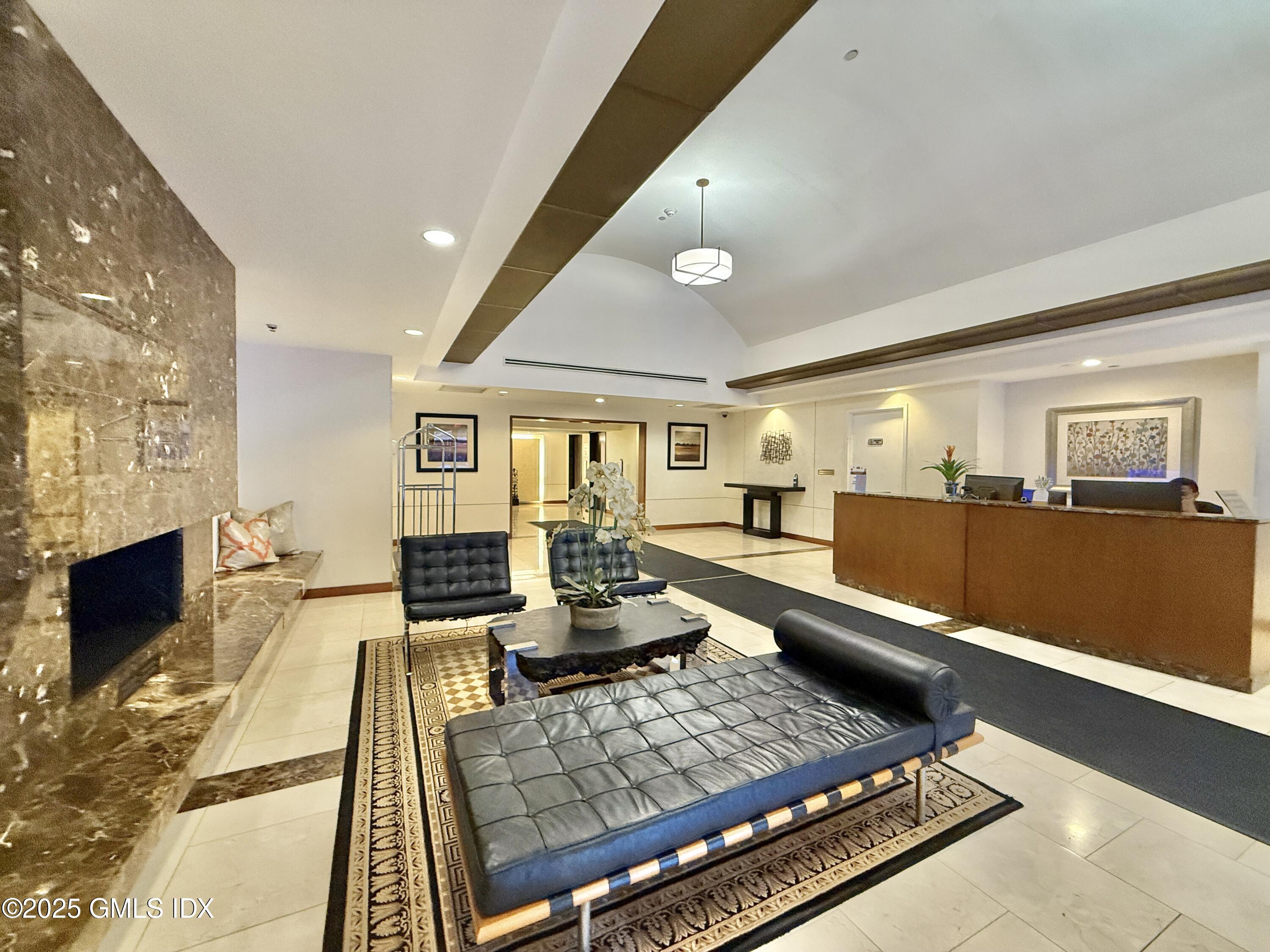 25 Forest Street, Unit 8C Stamford, CT 06901 - Photo 16 of 25 a living room with furniture and a fireplace