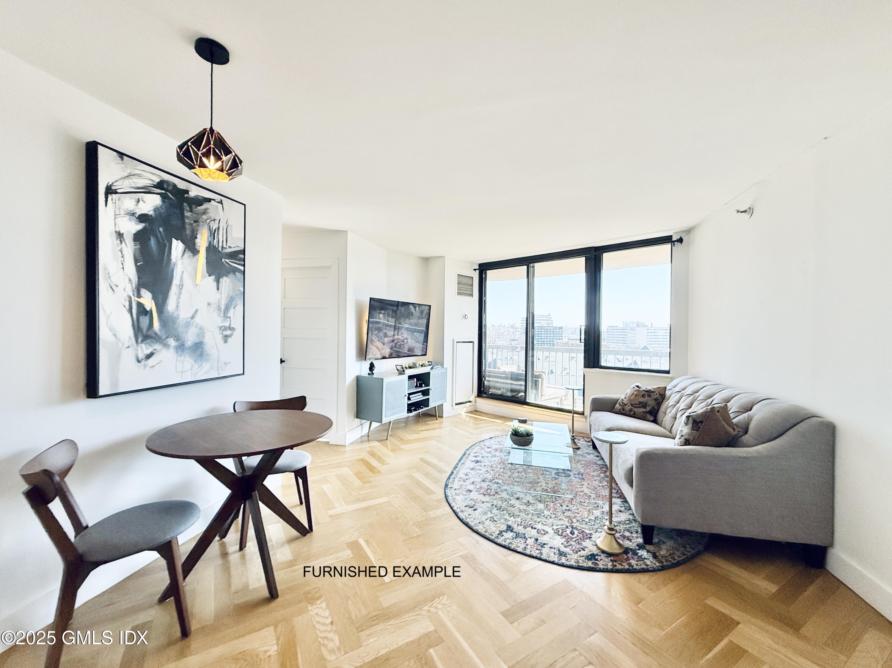 25 Forest Street, Unit 8C Stamford, CT 06901 - Photo 2 of 25 a living room with furniture and a large window
