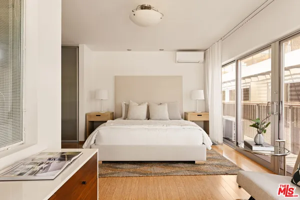 a spacious bedroom with a large bed and a couch