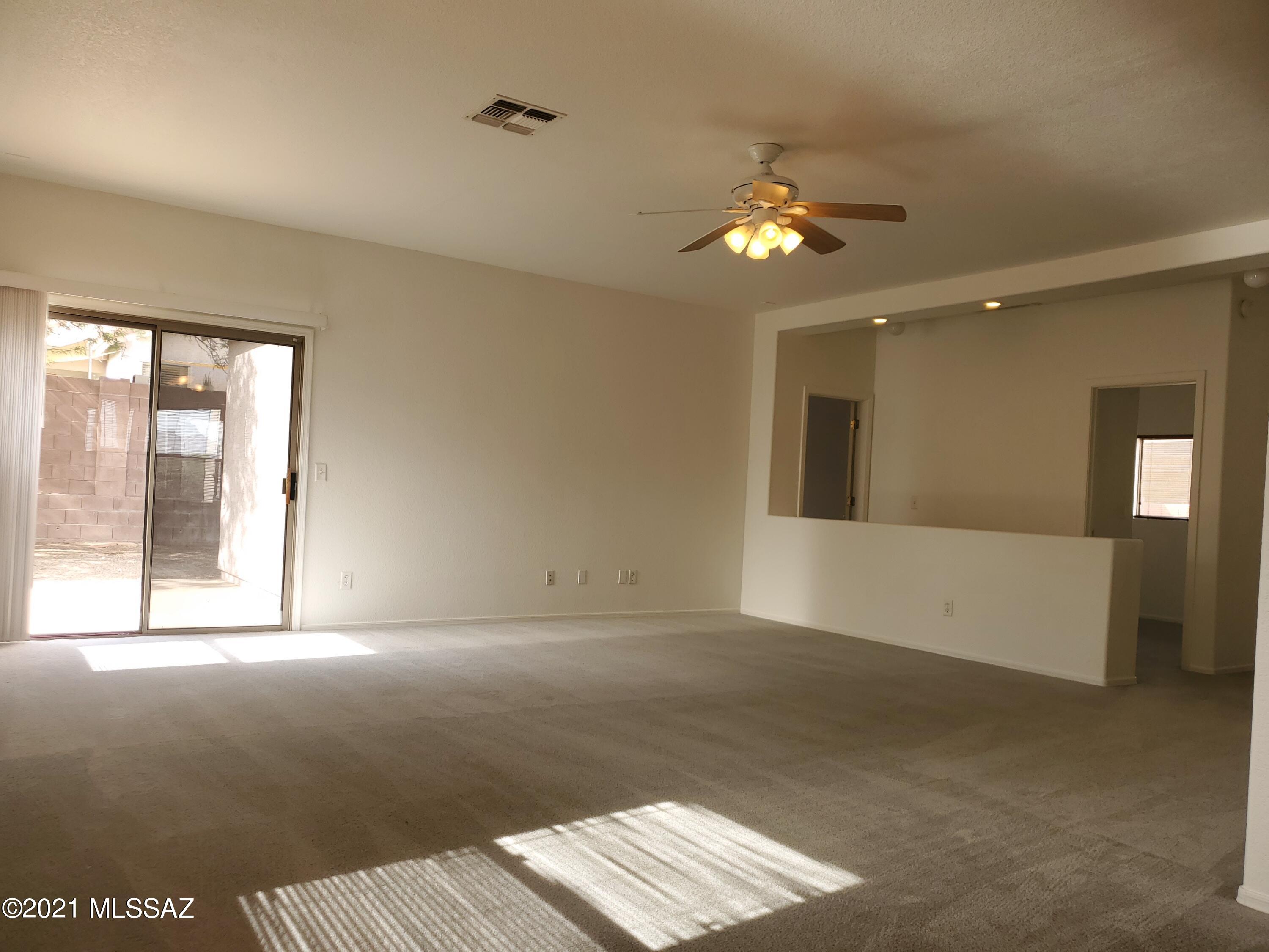 3455 North Boyce Spring Lane Tucson, AZ 85745 - Photo 4 of 21 a view of wooden floor and chandelier fan in a room
