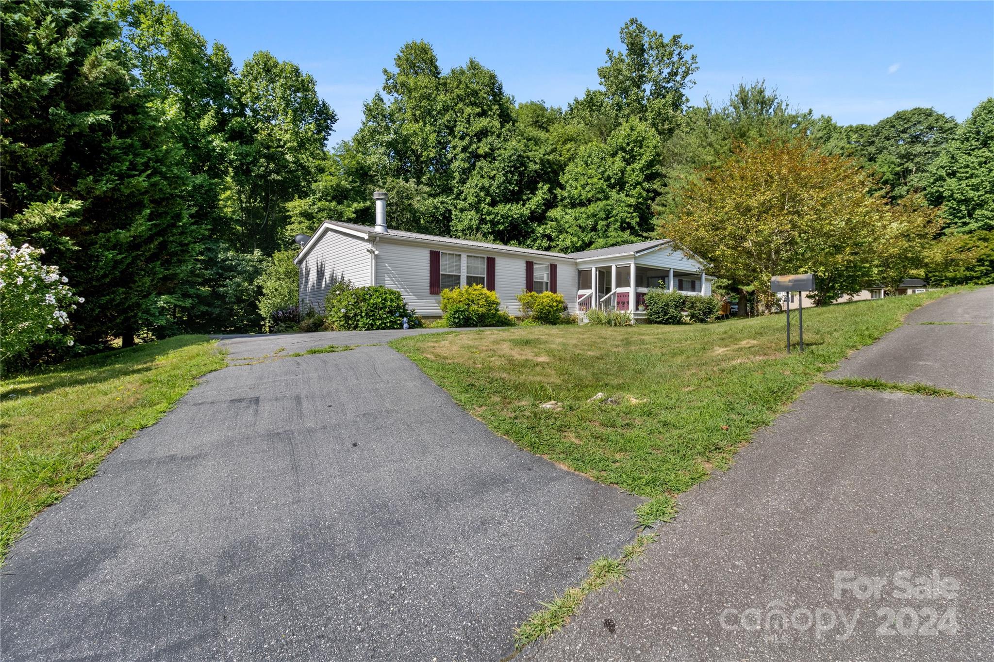 65 Fraser Hill Drive Mars Hill, NC 28754 - Photo 34 of 39 a front view of a house with a yard and trees