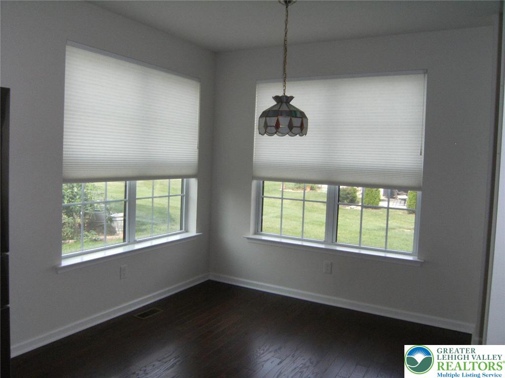 4088 Eveningstar Road Emmaus, PA 18049 - Photo 22 of 78 a view of an empty room with wooden floor and windows