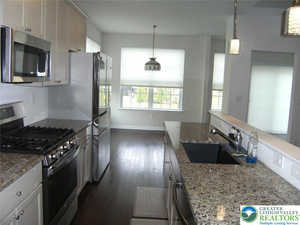 4088 Eveningstar Road Emmaus, PA 18049 - Photo 25 of 78 a kitchen with stainless steel appliances granite countertop a sink stove and refrigerator