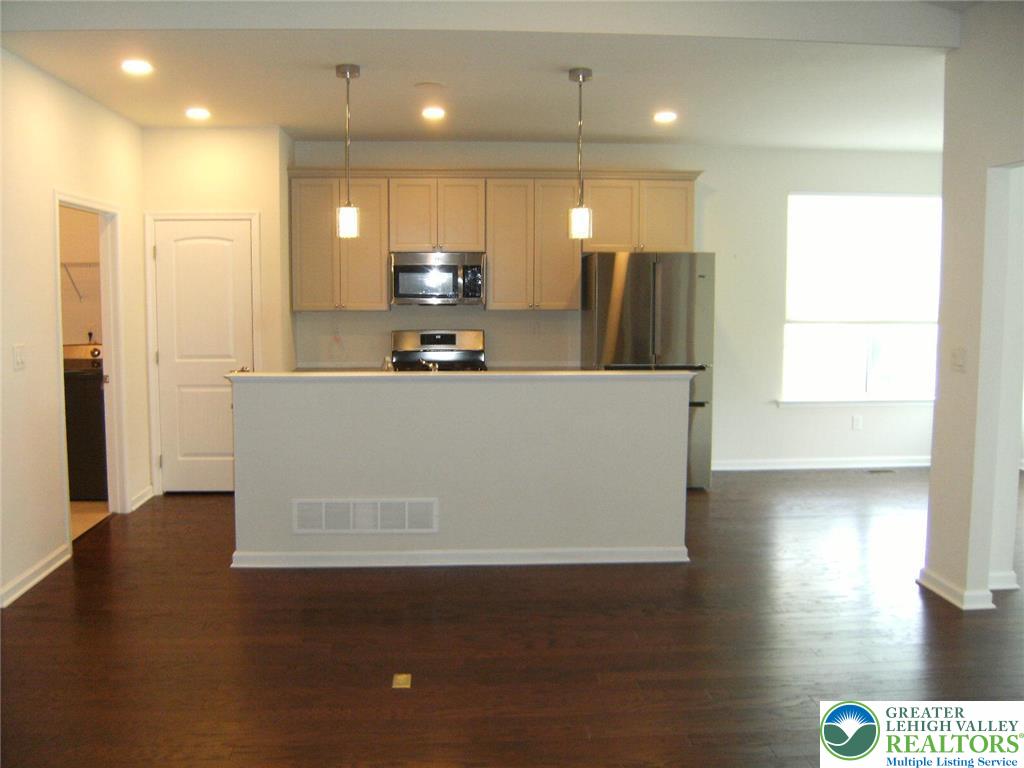 4088 Eveningstar Road Emmaus, PA 18049 - Photo 26 of 78 a view of a kitchen with stainless steel appliances wooden floor and a refrigerator
