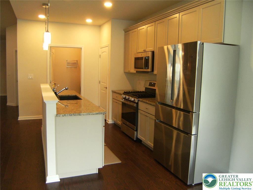 4088 Eveningstar Road Emmaus, PA 18049 - Photo 45 of 78 a kitchen with a refrigerator a stove top oven and a sink