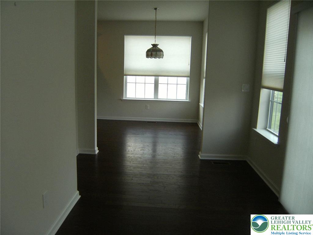 4088 Eveningstar Road Emmaus, PA 18049 - Photo 47 of 78 a view of an empty room with wooden floor and a window