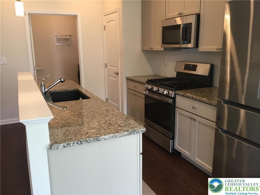4088 Eveningstar Road Emmaus, PA 18049 - Photo 55 of 78 a kitchen with stainless steel appliances granite countertop a refrigerator stove and microwave