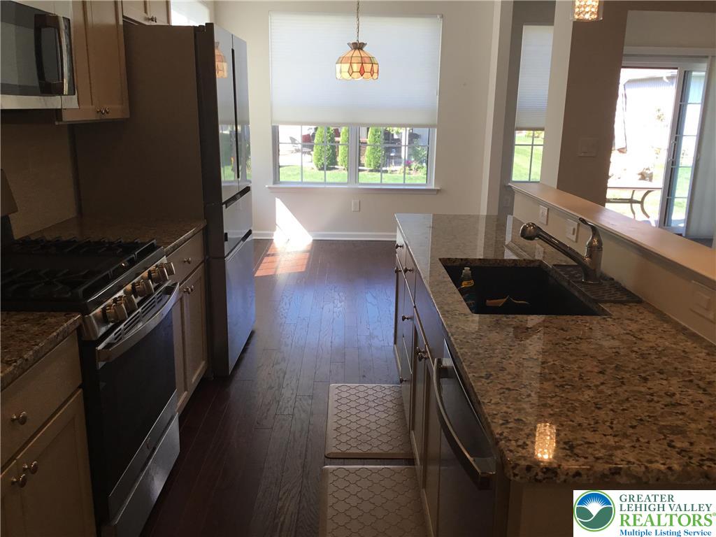4088 Eveningstar Road Emmaus, PA 18049 - Photo 56 of 78 a kitchen with granite countertop a stove and a refrigerator