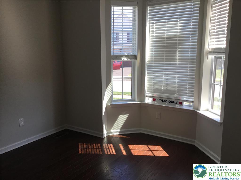 4088 Eveningstar Road Emmaus, PA 18049 - Photo 76 of 78 a view of an empty room with wooden floor and a window