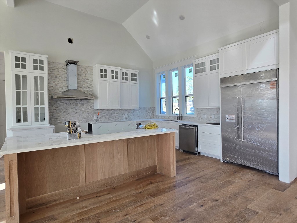 15408 Highlander Court Montgomery, TX 77356 - Photo 11 of 35 a large kitchen with kitchen island a sink stainless steel appliances and cabinets