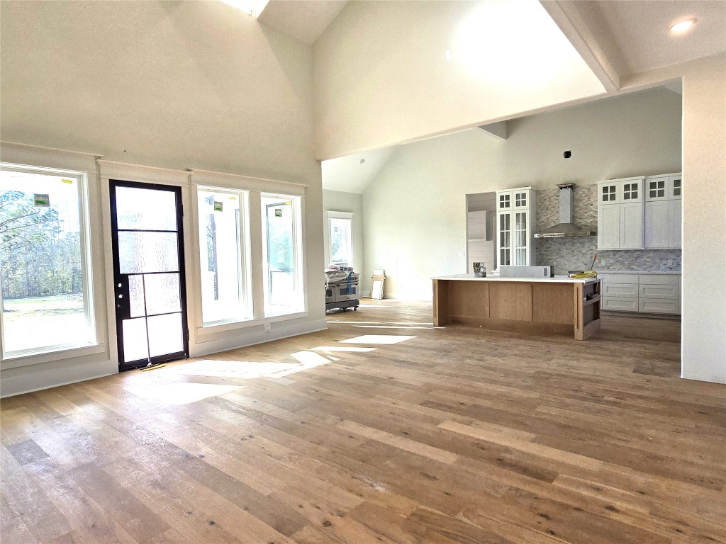 15408 Highlander Court Montgomery, TX 77356 - Photo 15 of 35 a view of a kitchen with kitchen island stainless steel appliances refrigerator and wooden floor