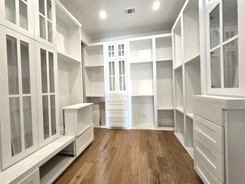 15408 Highlander Court Montgomery, TX 77356 - Photo 24 of 35 a view of walk in closet with wooden floor and floors