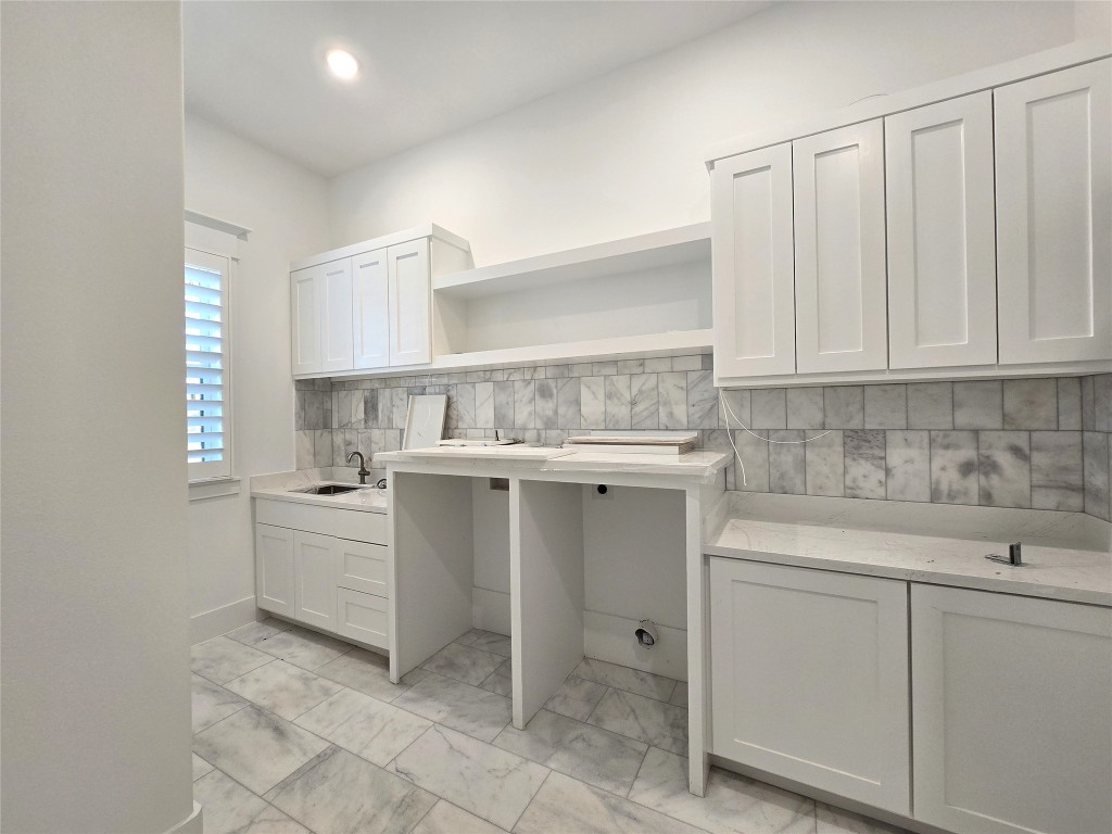 15408 Highlander Court Montgomery, TX 77356 - Photo 26 of 35 a kitchen with white cabinets and white appliances