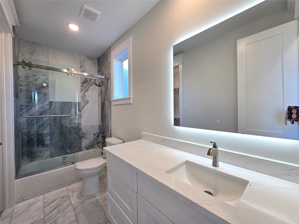 15408 Highlander Court Montgomery, TX 77356 - Photo 29 of 35 a bathroom with a bathtub shower sink mirror and toilet