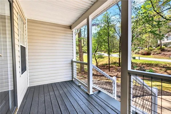 a view of a balcony with wooden floor