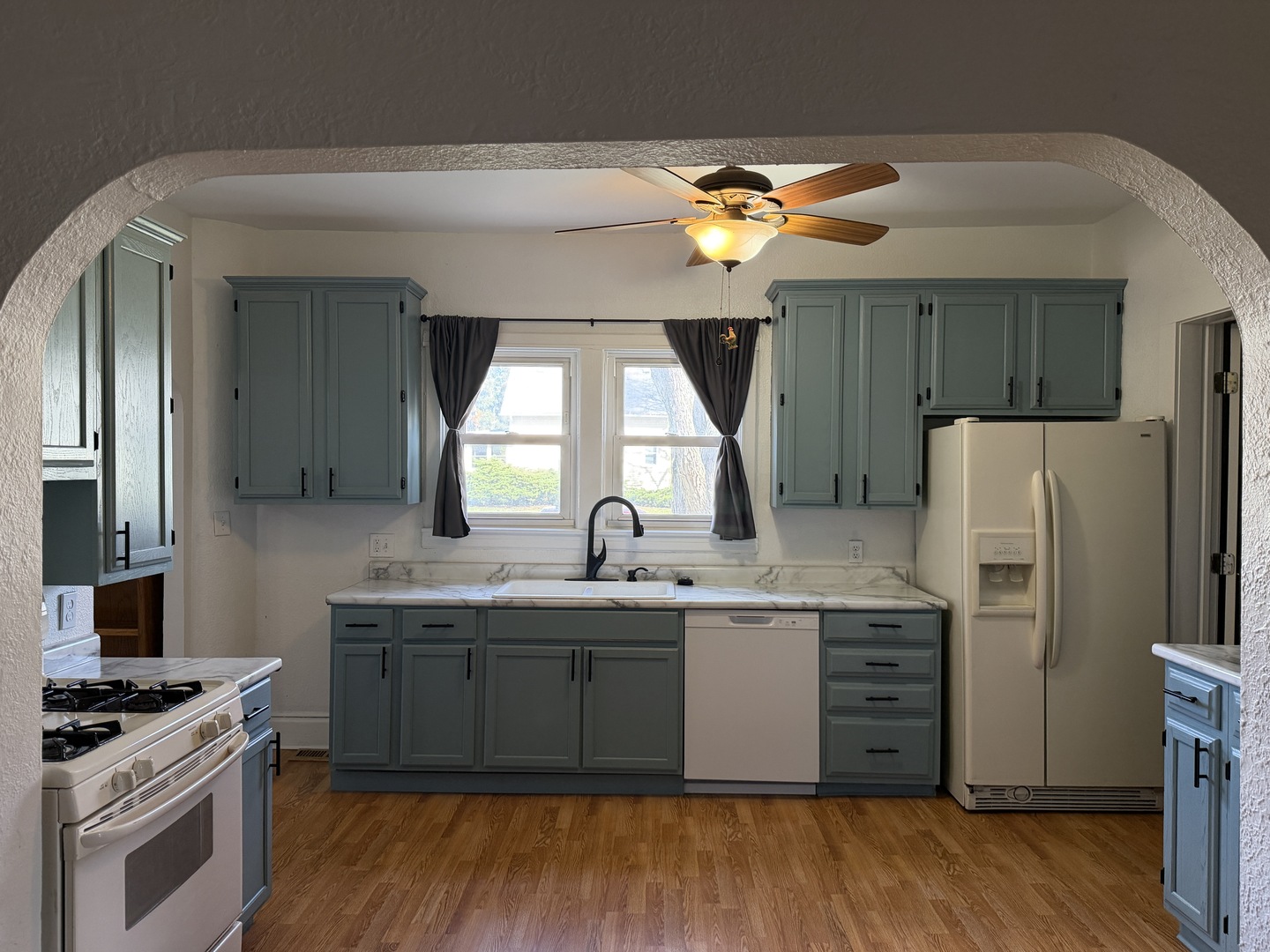 307 East Willow Street Normal, IL 61761 - Photo 7 of 10 a kitchen with stainless steel appliances a sink cabinets and wooden floor