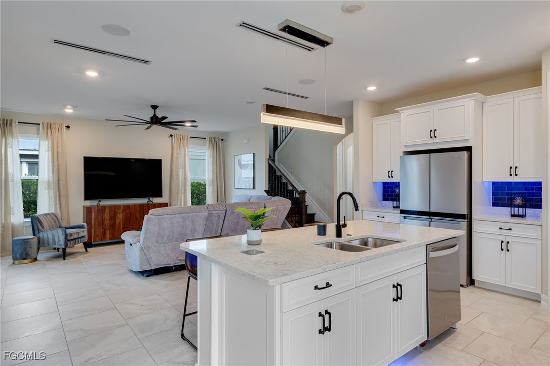 16549 Timber Lane Punta Gorda, FL 33982 - Photo 14 of 30 a kitchen with kitchen island a sink appliances and a living room