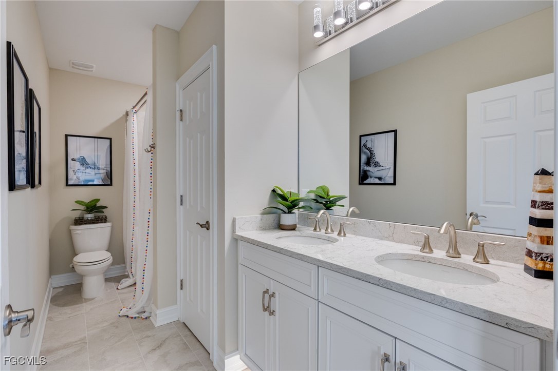 16549 Timber Lane Punta Gorda, FL 33982 - Photo 24 of 30 a bathroom with a granite countertop sink and a mirror