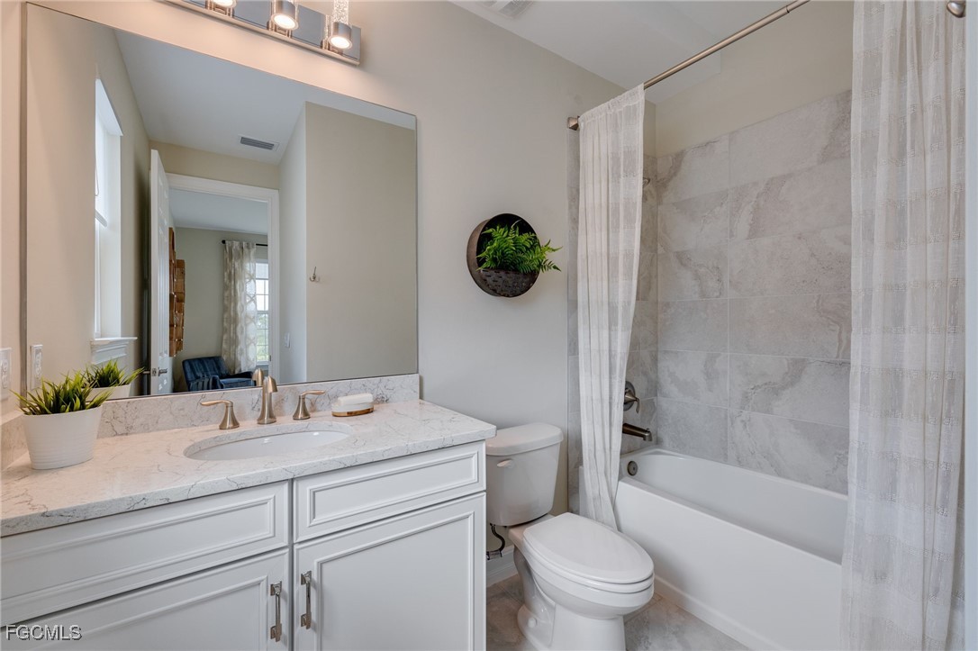 16549 Timber Lane Punta Gorda, FL 33982 - Photo 26 of 30 a bathroom with a granite countertop sink a toilet and shower