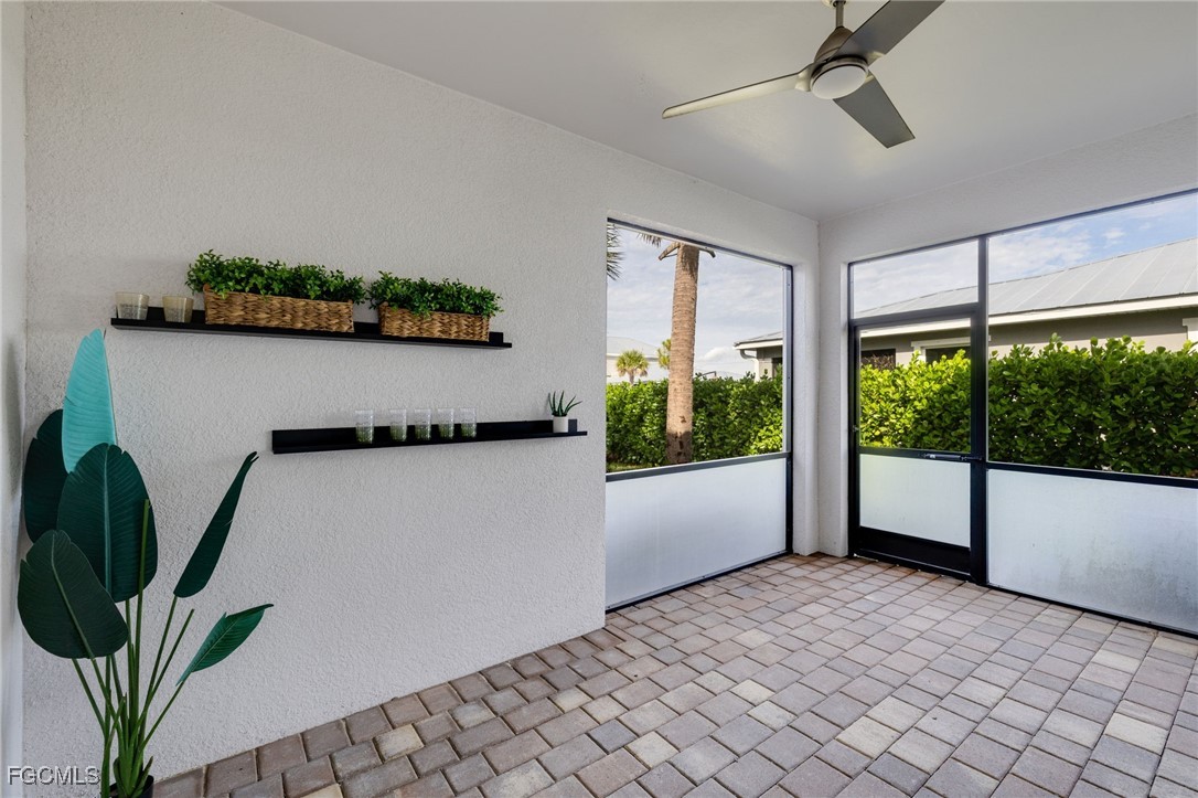 16549 Timber Lane Punta Gorda, FL 33982 - Photo 28 of 30 a living room with furniture and a floor to ceiling window