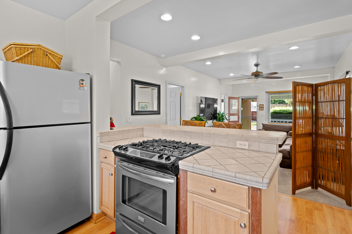 66-1685 Kohala Mountain Road Kamuela, HI 96743 - Photo 17 of 26 a kitchen with stainless steel appliances granite countertop a refrigerator and a stove