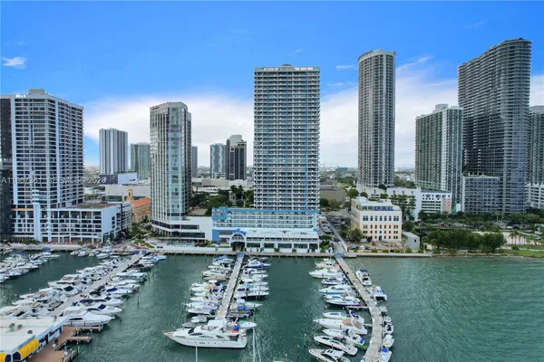 a large body of water with a building and trees in the background