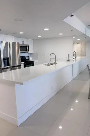 a large kitchen with stainless steel appliances