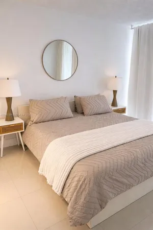 a bedroom with a bed and a lamp