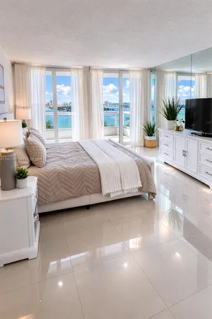 a bedroom with a large bed and a flat tv screen