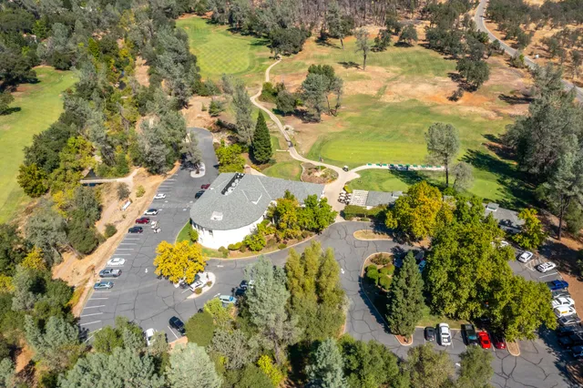an aerial view of residential houses with outdoor space and swimming pool
